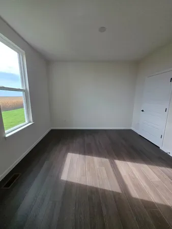 a view of wooden floor and windows in a room