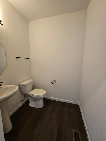a white toilet sitting next to a bathroom sink