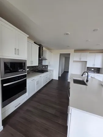 a kitchen with granite countertop a stove and a sink