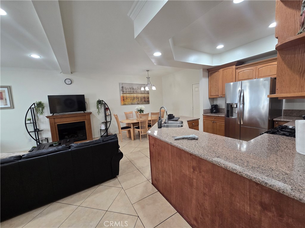 8026 Telegraph Road Downey, CA 90240 - Photo 8 of 26 a large kitchen with kitchen island a large counter top stainless steel appliances and cabinets