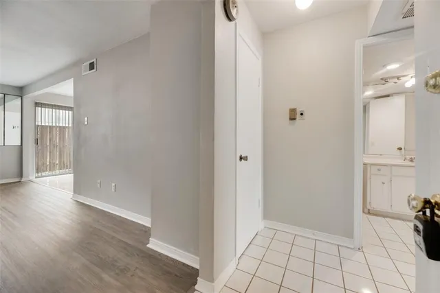 a view of an empty room and wooden floor