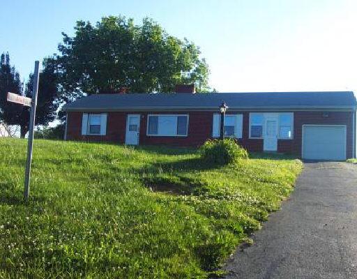 1163 Ross Road Vinton, VA 24179 - Photo 1 of 1 a brick house with a big yard plants and large trees