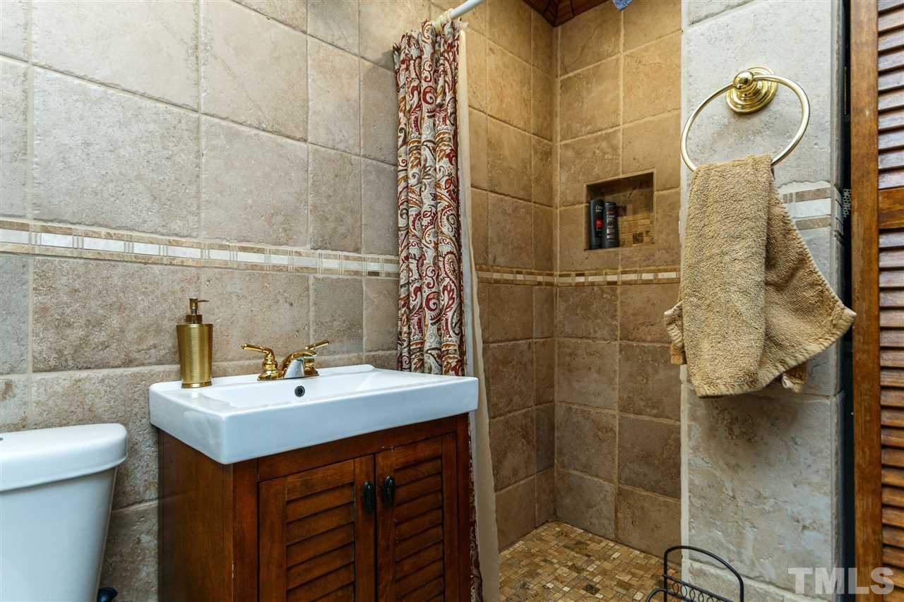 5220 Revere Road Durham, NC 27713 - Photo 14 of 30 a bathroom with a sink toilet and shower