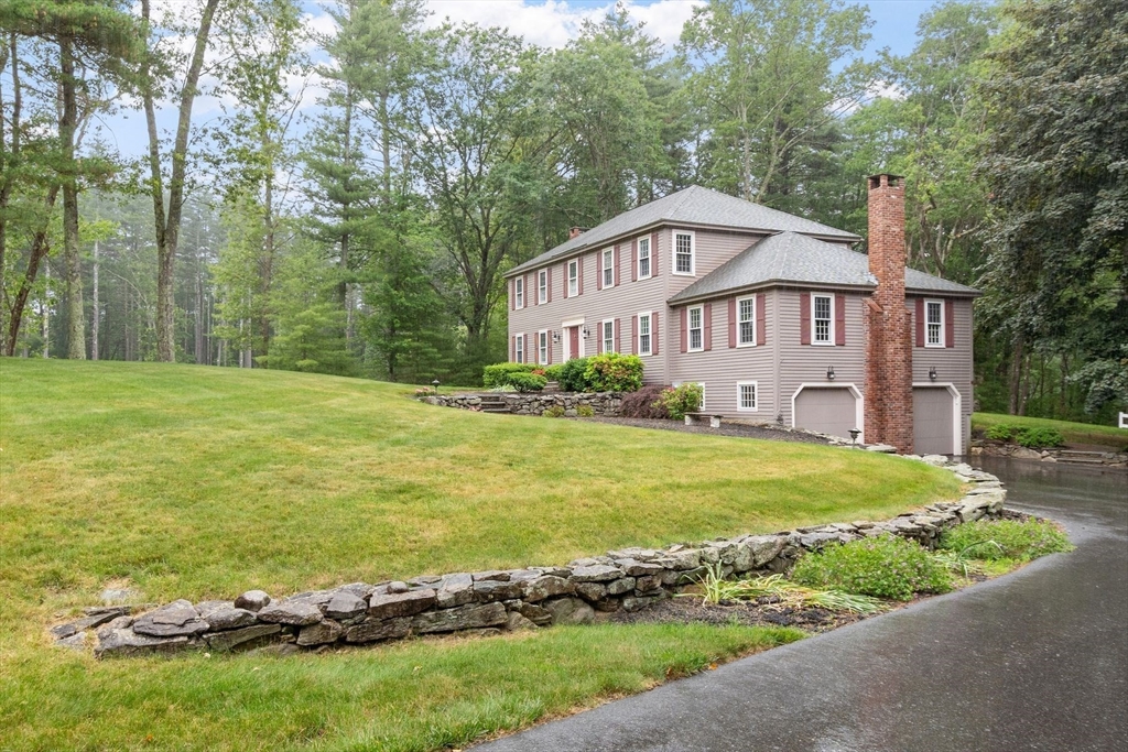 244 Hunters Ridge Road Concord, MA 01742 - Photo 1 of 41 a view of a big house with a big yard and large trees