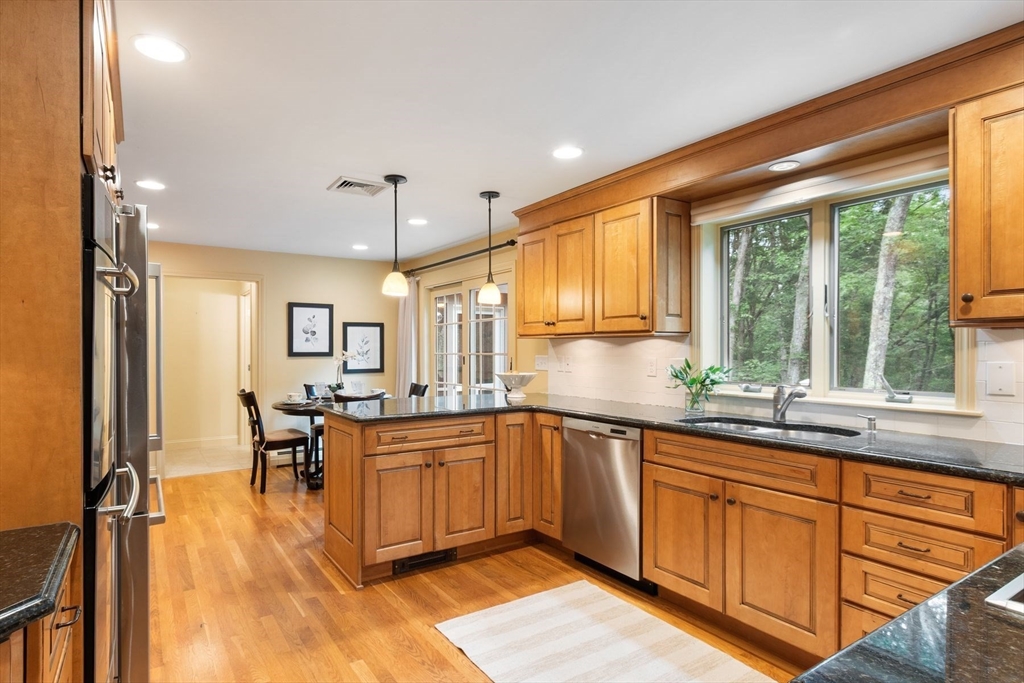244 Hunters Ridge Road Concord, MA 01742 - Photo 11 of 41 a kitchen with lots of counter top space and dining table