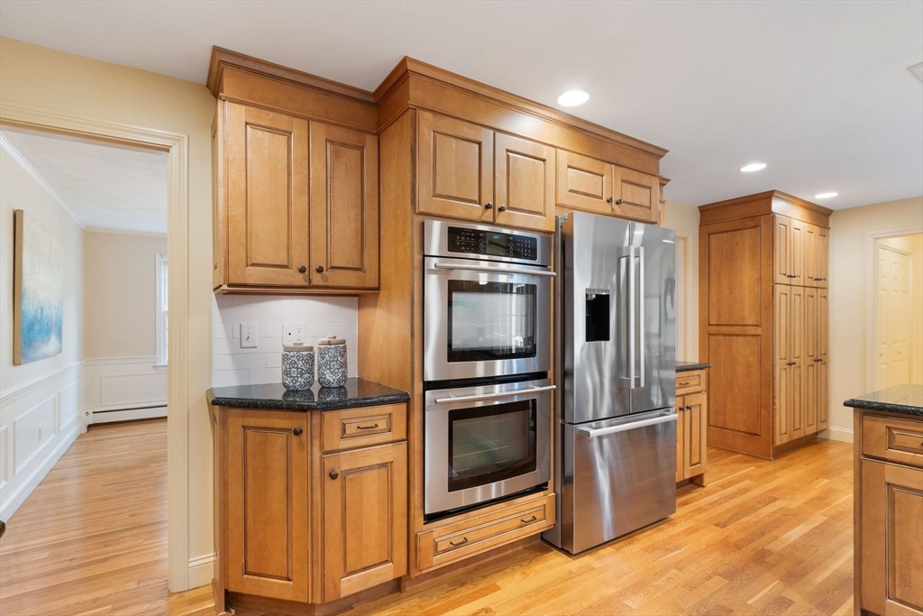 244 Hunters Ridge Road Concord, MA 01742 - Photo 12 of 41 a kitchen with stainless steel appliances granite countertop a refrigerator and a stove top oven
