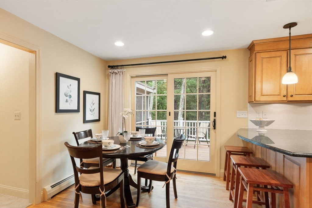 244 Hunters Ridge Road Concord, MA 01742 - Photo 15 of 41 a view of a dining room with furniture and wooden floor