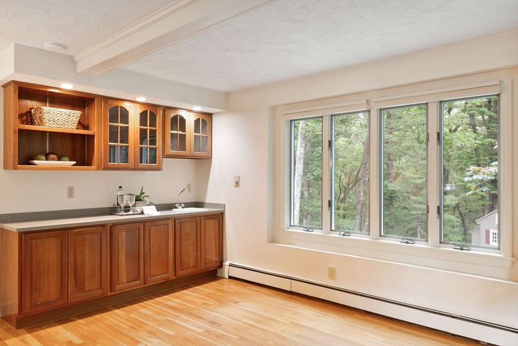 244 Hunters Ridge Road Concord, MA 01742 - Photo 20 of 41 a view of an empty room with wooden floor and a window