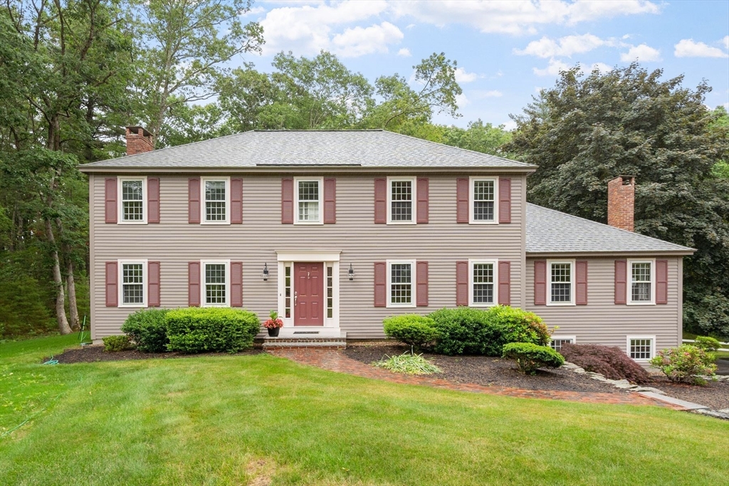 244 Hunters Ridge Road Concord, MA 01742 - Photo 2 of 41 a front view of a house with a yard