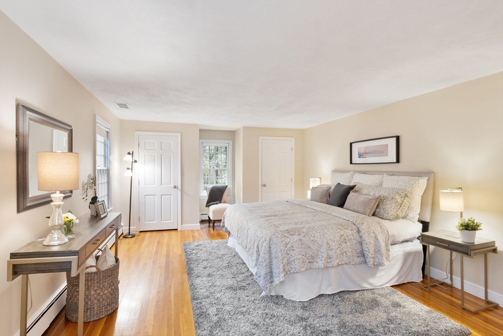 244 Hunters Ridge Road Concord, MA 01742 - Photo 24 of 41 a spacious bedroom with a bed a couch and dresser