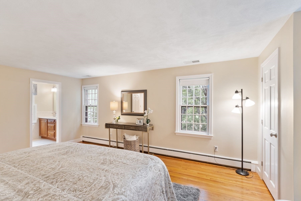 244 Hunters Ridge Road Concord, MA 01742 - Photo 25 of 41 a spacious bedroom with a bed and a window