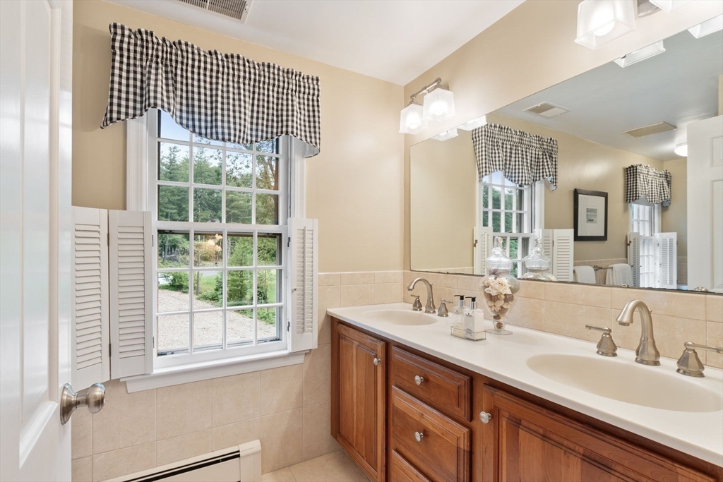 244 Hunters Ridge Road Concord, MA 01742 - Photo 26 of 41 a bathroom with a sink double vanity and a shower