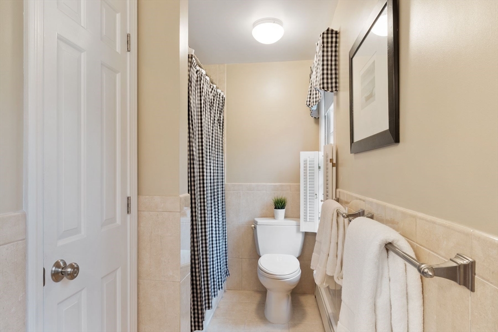 244 Hunters Ridge Road Concord, MA 01742 - Photo 27 of 41 a white toilet sitting next to a bathroom sink