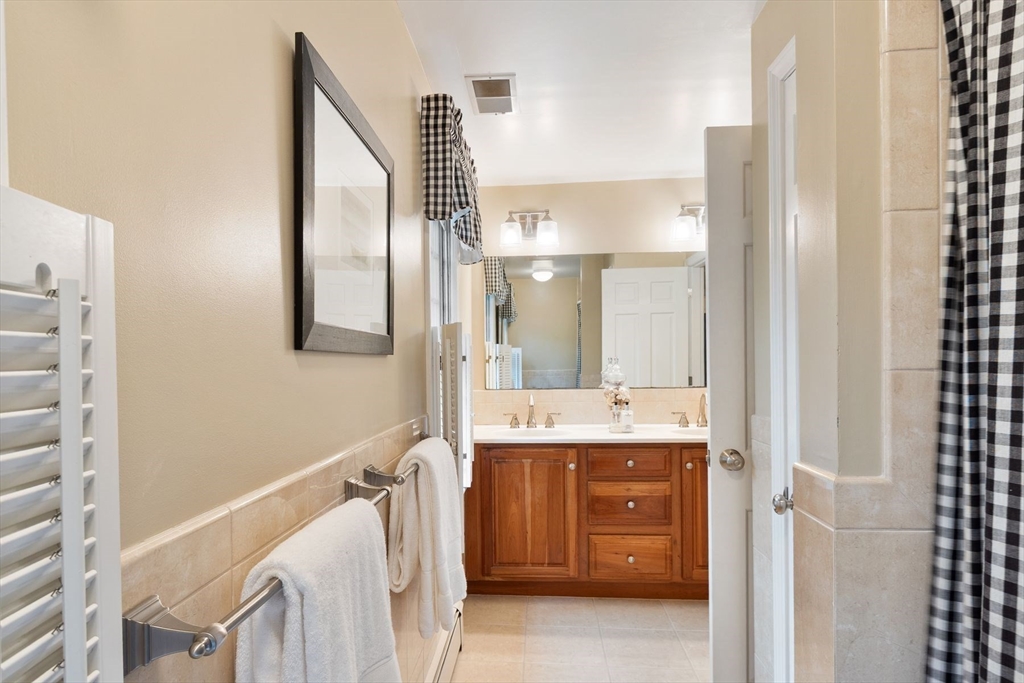 244 Hunters Ridge Road Concord, MA 01742 - Photo 28 of 41 a bathroom with a double vanity sink and mirror
