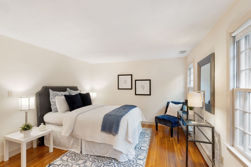 244 Hunters Ridge Road Concord, MA 01742 - Photo 29 of 41 a bedroom with a bed and wooden floor