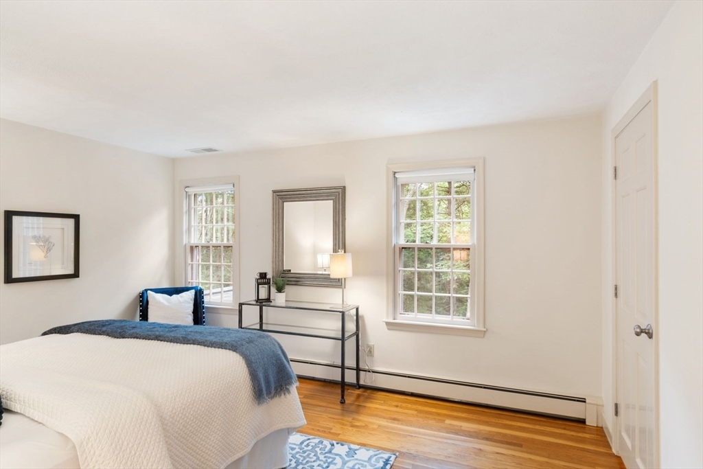 244 Hunters Ridge Road Concord, MA 01742 - Photo 30 of 41 a bedroom with a bed and wooden floor