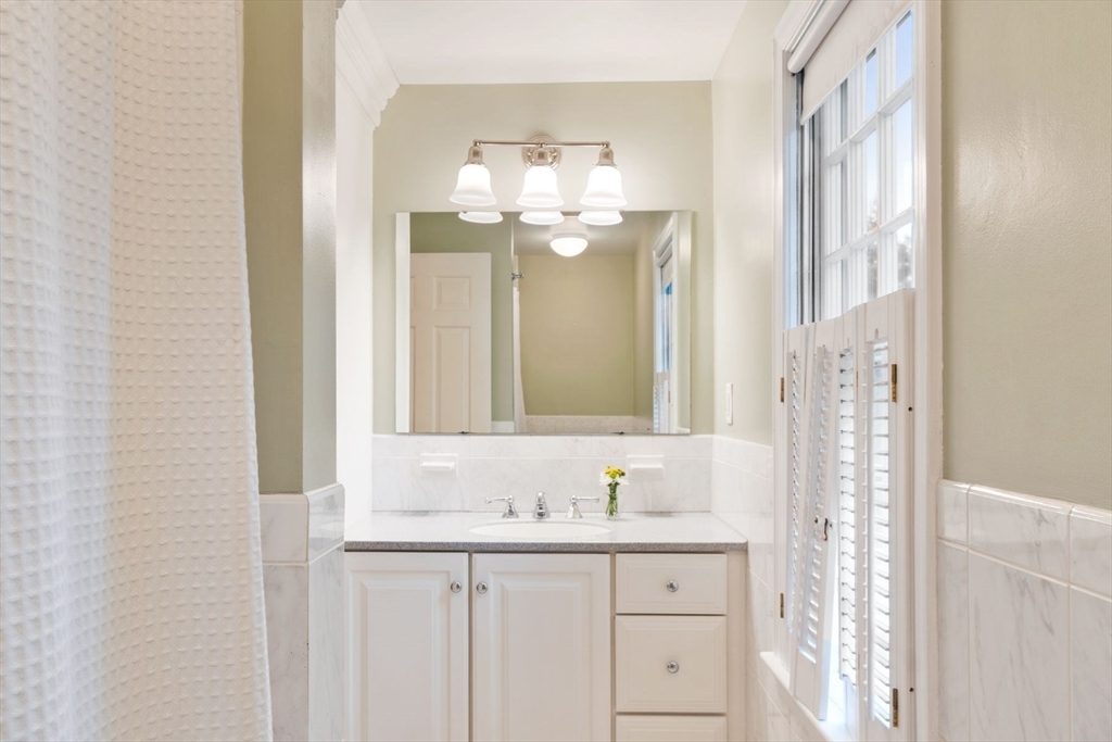 244 Hunters Ridge Road Concord, MA 01742 - Photo 33 of 41 a bathroom with a sink and a mirror