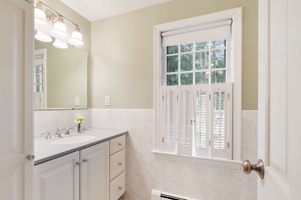 244 Hunters Ridge Road Concord, MA 01742 - Photo 34 of 41 a bathroom with a sink vanity and a mirror