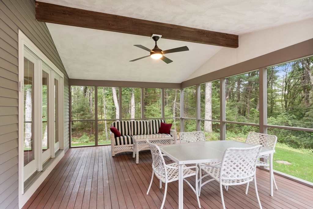 244 Hunters Ridge Road Concord, MA 01742 - Photo 37 of 41 a dining room with furniture a chandelier and wooden floor