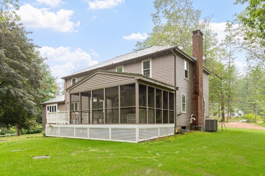 244 Hunters Ridge Road Concord, MA 01742 - Photo 39 of 41 a view of a house with a yard and a large tree