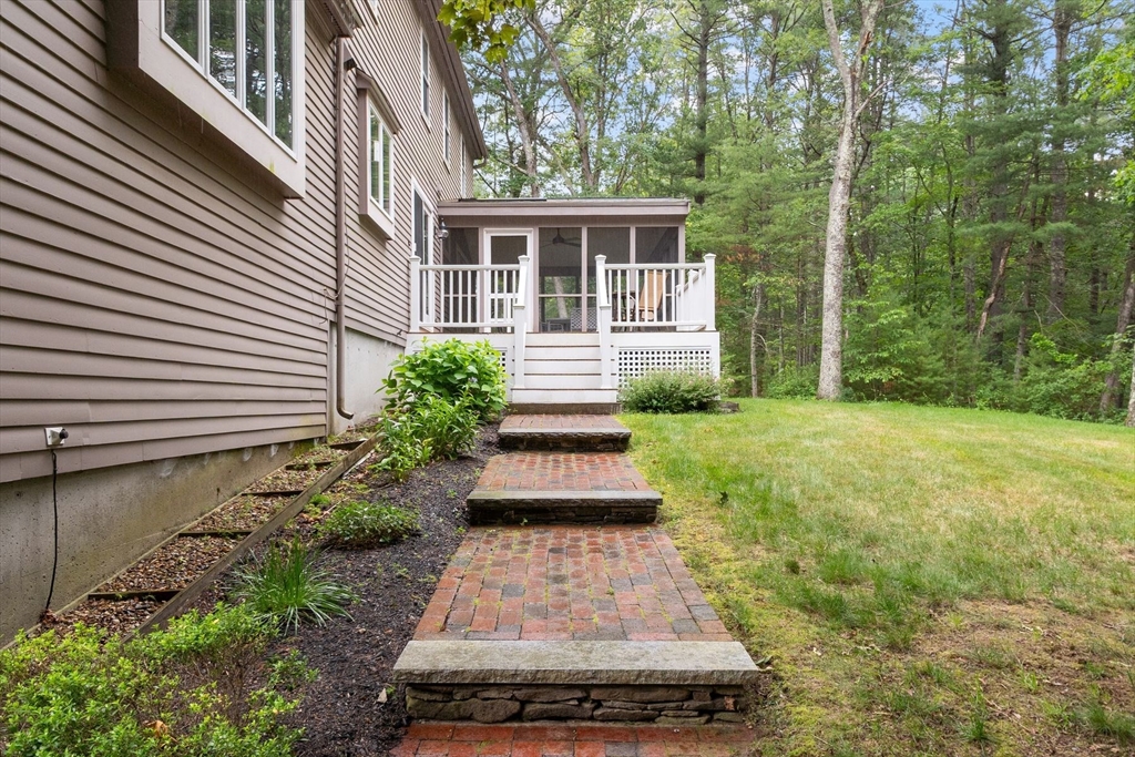244 Hunters Ridge Road Concord, MA 01742 - Photo 40 of 41 a front view of a house with a yard
