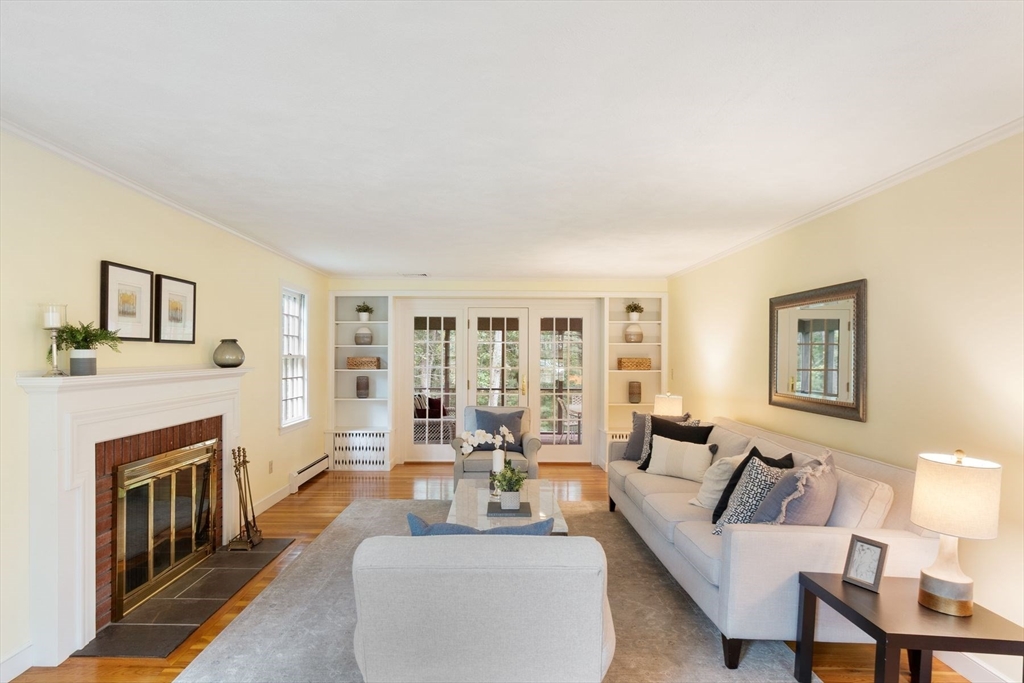 244 Hunters Ridge Road Concord, MA 01742 - Photo 6 of 41 a living room with furniture large window and a fireplace