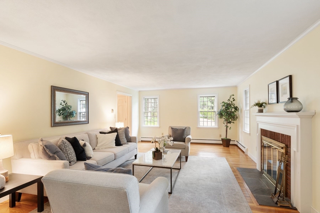 244 Hunters Ridge Road Concord, MA 01742 - Photo 7 of 41 a living room with furniture large window and a fireplace