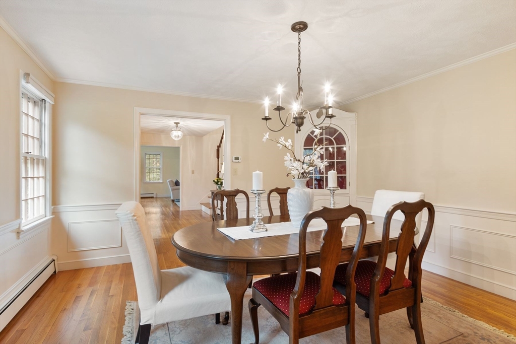 244 Hunters Ridge Road Concord, MA 01742 - Photo 9 of 41 a view of a dining room with furniture wooden floor and chandelier