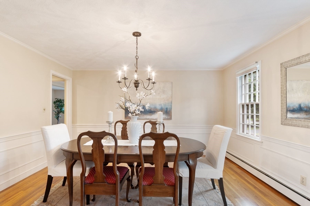 244 Hunters Ridge Road Concord, MA 01742 - Photo 10 of 41 a view of a dining room with furniture a chandelier and wooden floor