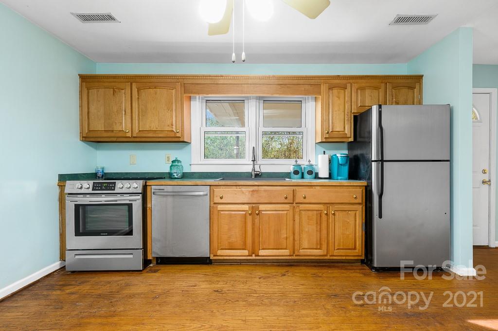 14 Browning Road Waynesville, NC 28786 - Photo 11 of 26 a kitchen with stainless steel appliances granite countertop a refrigerator a stove a sink and a microwave