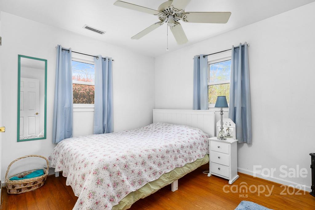 14 Browning Road Waynesville, NC 28786 - Photo 13 of 26 a bedroom with a bed and a chandelier