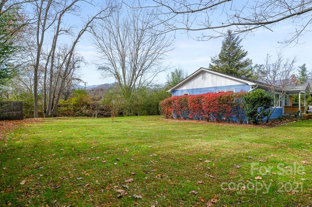 14 Browning Road Waynesville, NC 28786 - Photo 25 of 26 a backyard of a house with plants and large tree