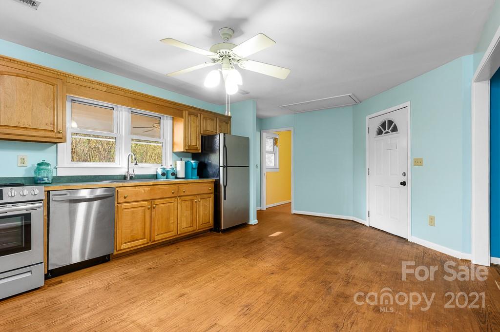 14 Browning Road Waynesville, NC 28786 - Photo 10 of 26 a kitchen with stainless steel appliances granite countertop a stove cabinets and wooden floor