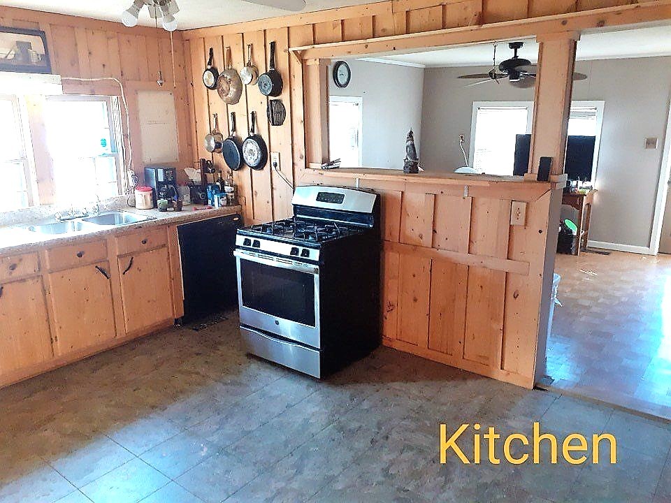 25 Old Union Road Paris, TN 38242 - Photo 2 of 5 a kitchen with stainless steel appliances granite countertop a stove and a sink