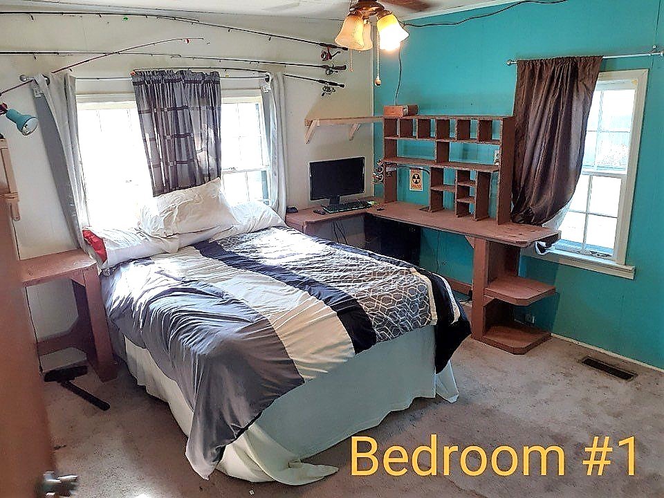 25 Old Union Road Paris, TN 38242 - Photo 3 of 5 a bed sitting in a bedroom next to a window