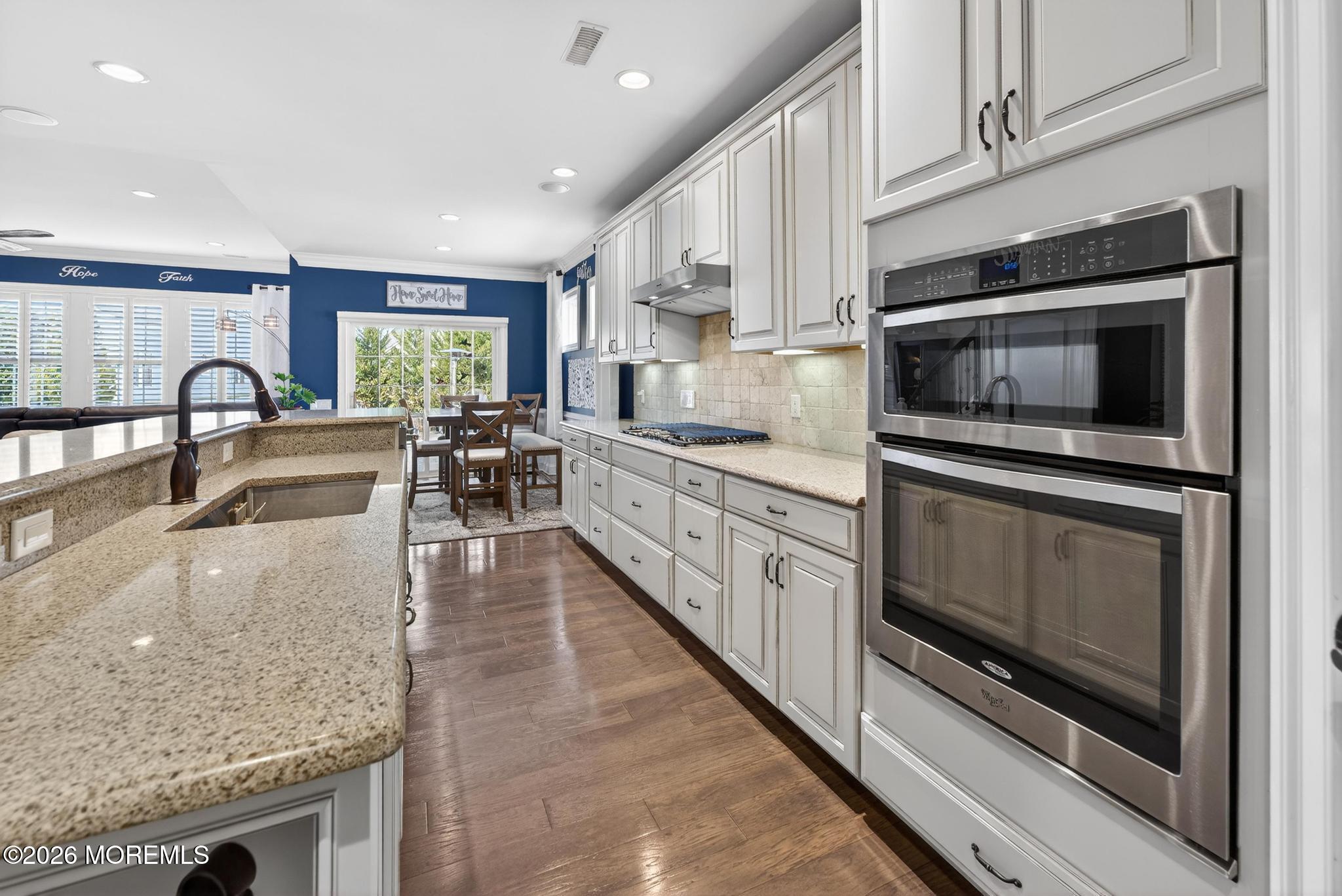 35 Addlestone Lane Manchester Township, NJ 08759 - Photo 11 of 44 a kitchen with stainless steel appliances granite countertop a stove a sink and a microwave