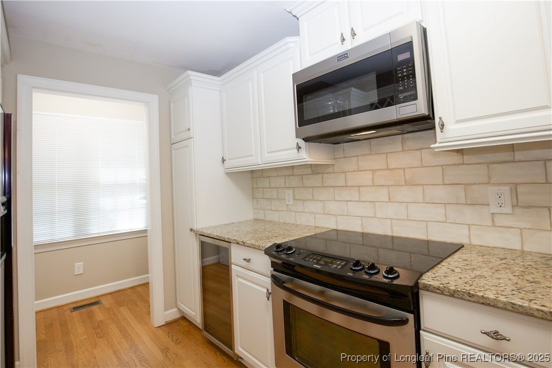 175 Knoll Road Southern Pines, NC 28387 - Photo 10 of 50 a stove top oven sitting inside of a kitchen