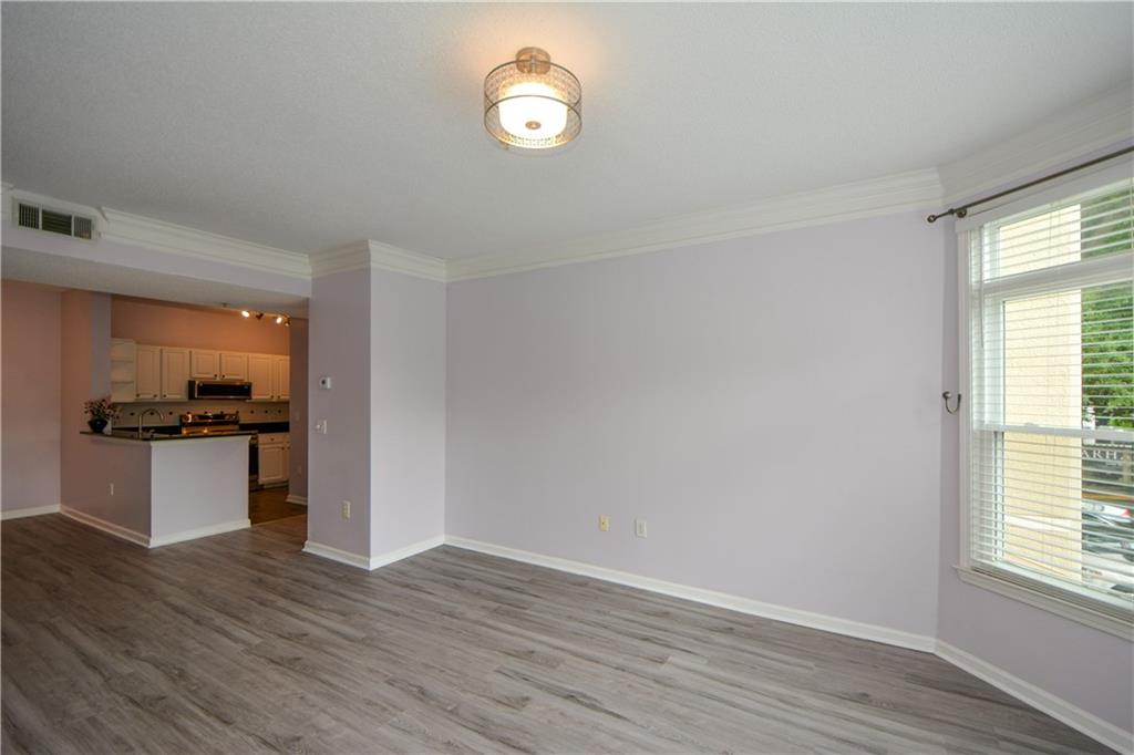 955 Juniper Street Northeast, Unit 4112 Atlanta, GA 30309 - Photo 12 of 27 a view of open kitchen with wooden floor and electronic appliances