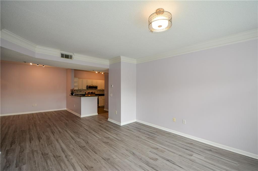955 Juniper Street Northeast, Unit 4112 Atlanta, GA 30309 - Photo 13 of 27 a view of empty room with wooden floor