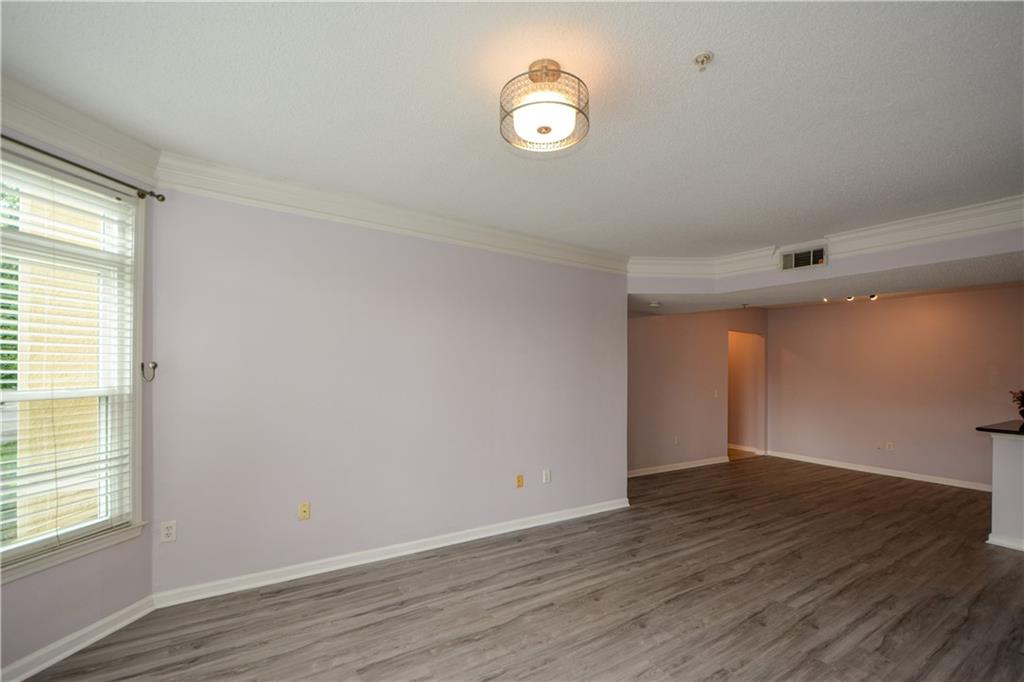 955 Juniper Street Northeast, Unit 4112 Atlanta, GA 30309 - Photo 14 of 27 an empty room with wooden floor and windows