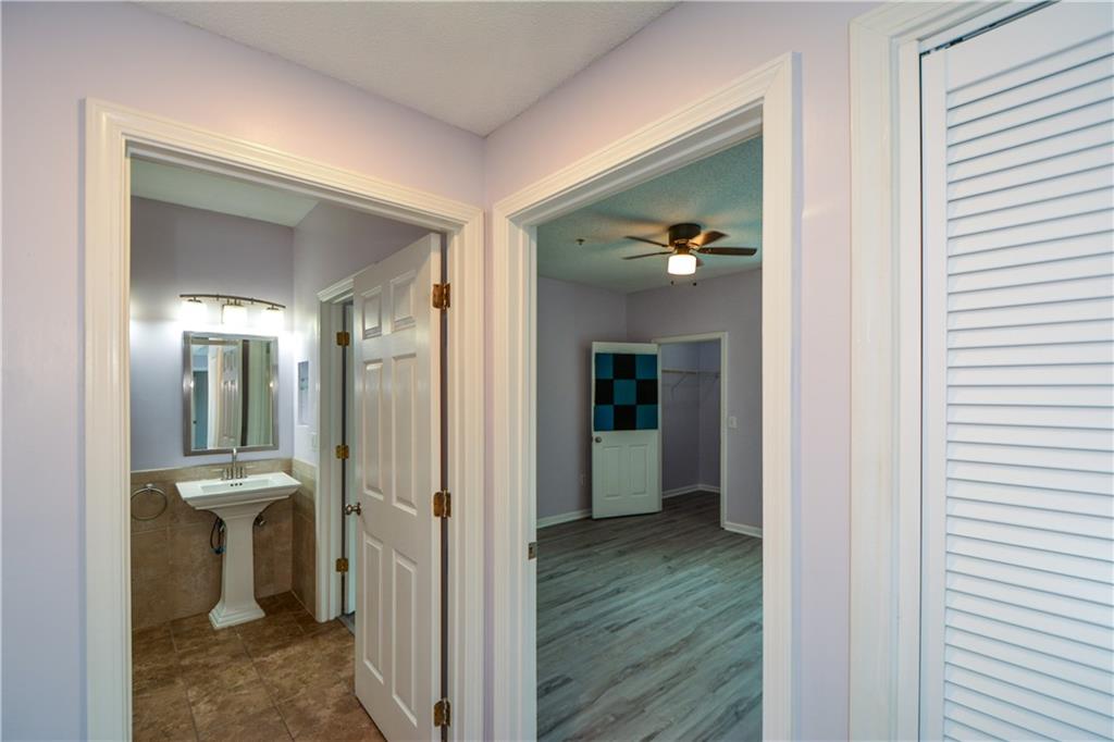 955 Juniper Street Northeast, Unit 4112 Atlanta, GA 30309 - Photo 16 of 27 a view of a hallway with wooden floor and a livingroom