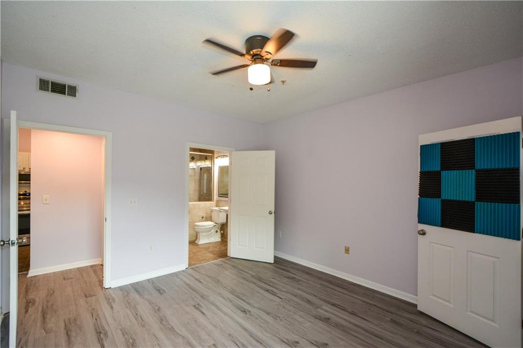955 Juniper Street Northeast, Unit 4112 Atlanta, GA 30309 - Photo 17 of 27 wooden floor in an empty room with a window