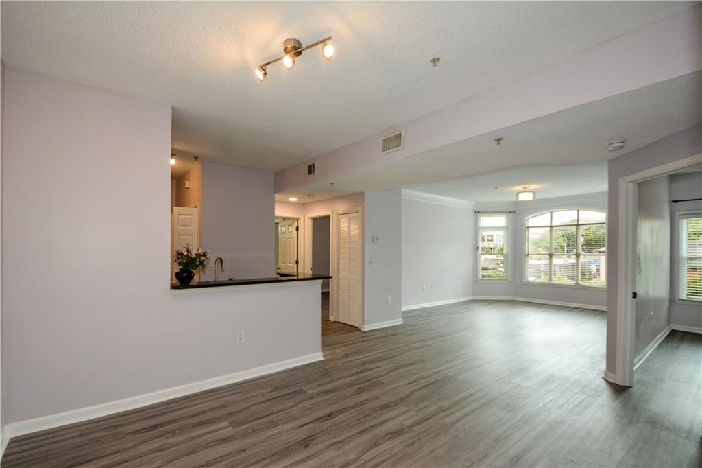 955 Juniper Street Northeast, Unit 4112 Atlanta, GA 30309 - Photo 18 of 27 a view of a room with wooden floor and window