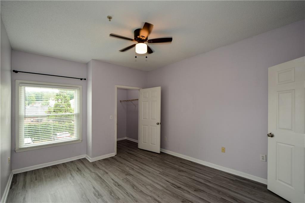 955 Juniper Street Northeast, Unit 4112 Atlanta, GA 30309 - Photo 26 of 27 a view of empty room with wooden floor and fan