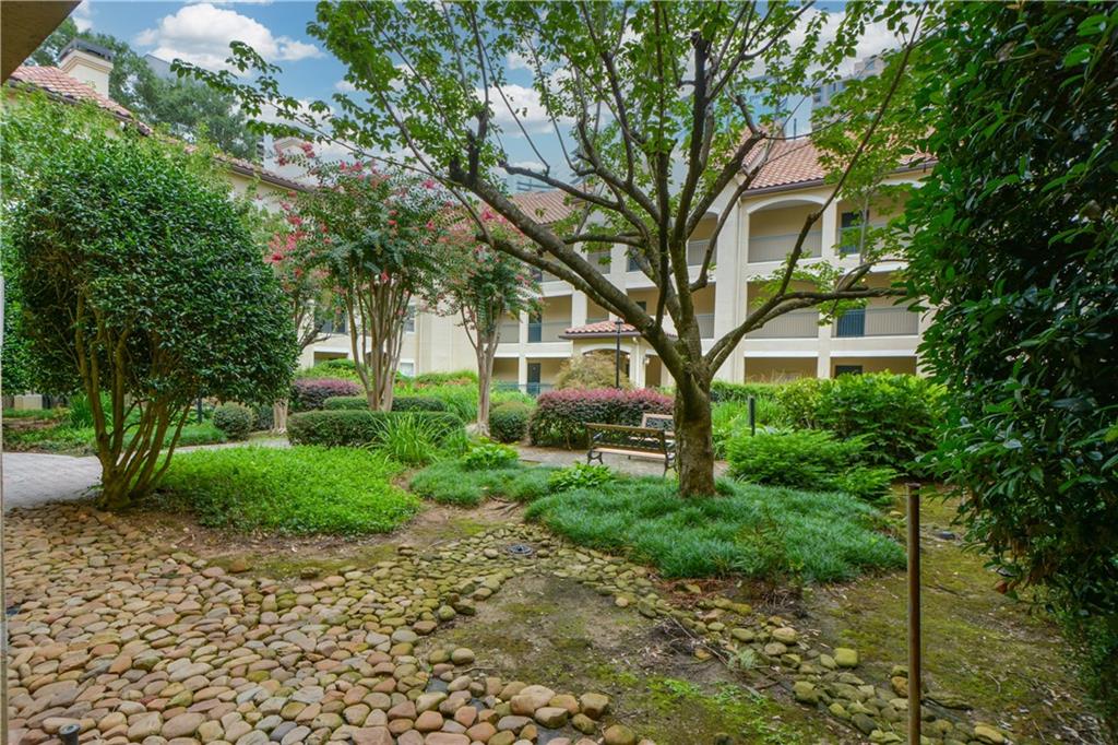 955 Juniper Street Northeast, Unit 4112 Atlanta, GA 30309 - Photo 27 of 27 a view of a house with a tree in the yard