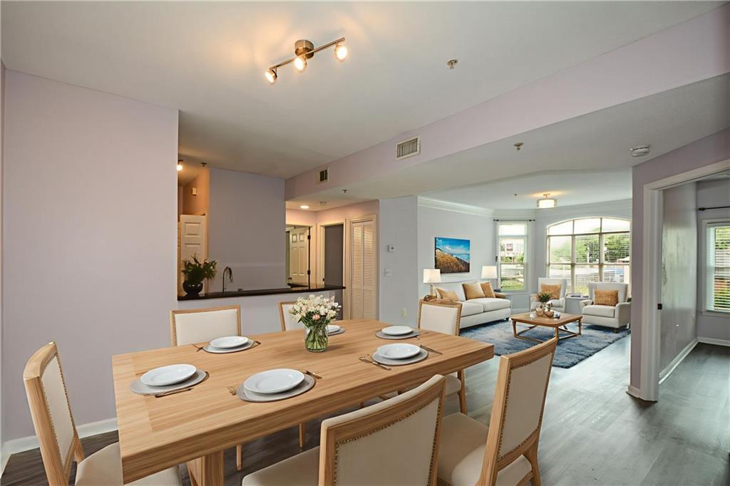 955 Juniper Street Northeast, Unit 4112 Atlanta, GA 30309 - Photo 3 of 27 a view of a dining room with furniture and wooden floor