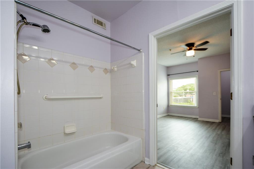 955 Juniper Street Northeast, Unit 4112 Atlanta, GA 30309 - Photo 7 of 27 a bathroom with a bathtub and a shower