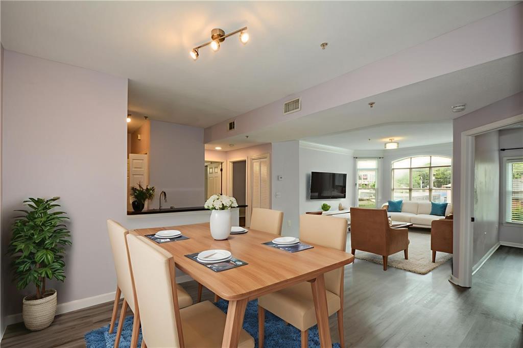 955 Juniper Street Northeast, Unit 4112 Atlanta, GA 30309 - Photo 9 of 27 a view of a dining room with furniture window and wooden floor