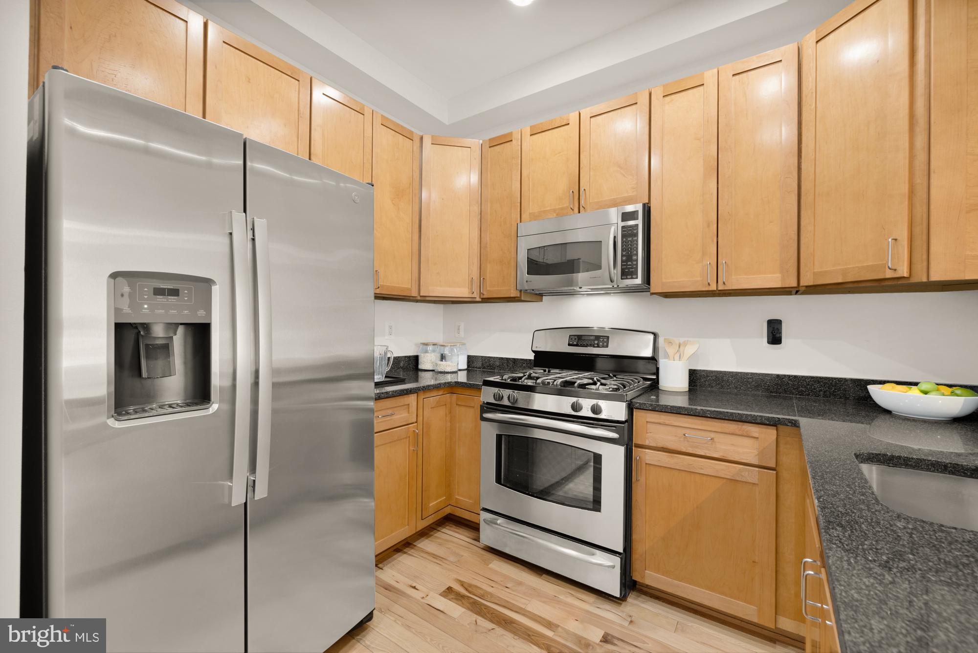 2713 Ontario Road Northwest, Unit 2 Washington, DC 20009 - Photo 11 of 33 a kitchen with stainless steel appliances granite countertop a stove a refrigerator and a sink