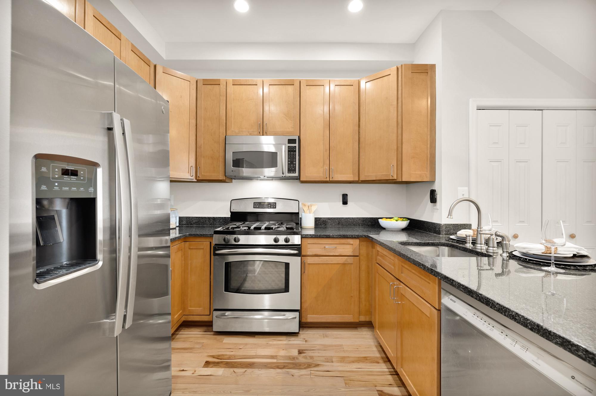 2713 Ontario Road Northwest, Unit 2 Washington, DC 20009 - Photo 12 of 33 a kitchen with stainless steel appliances granite countertop a stove a sink and a refrigerator